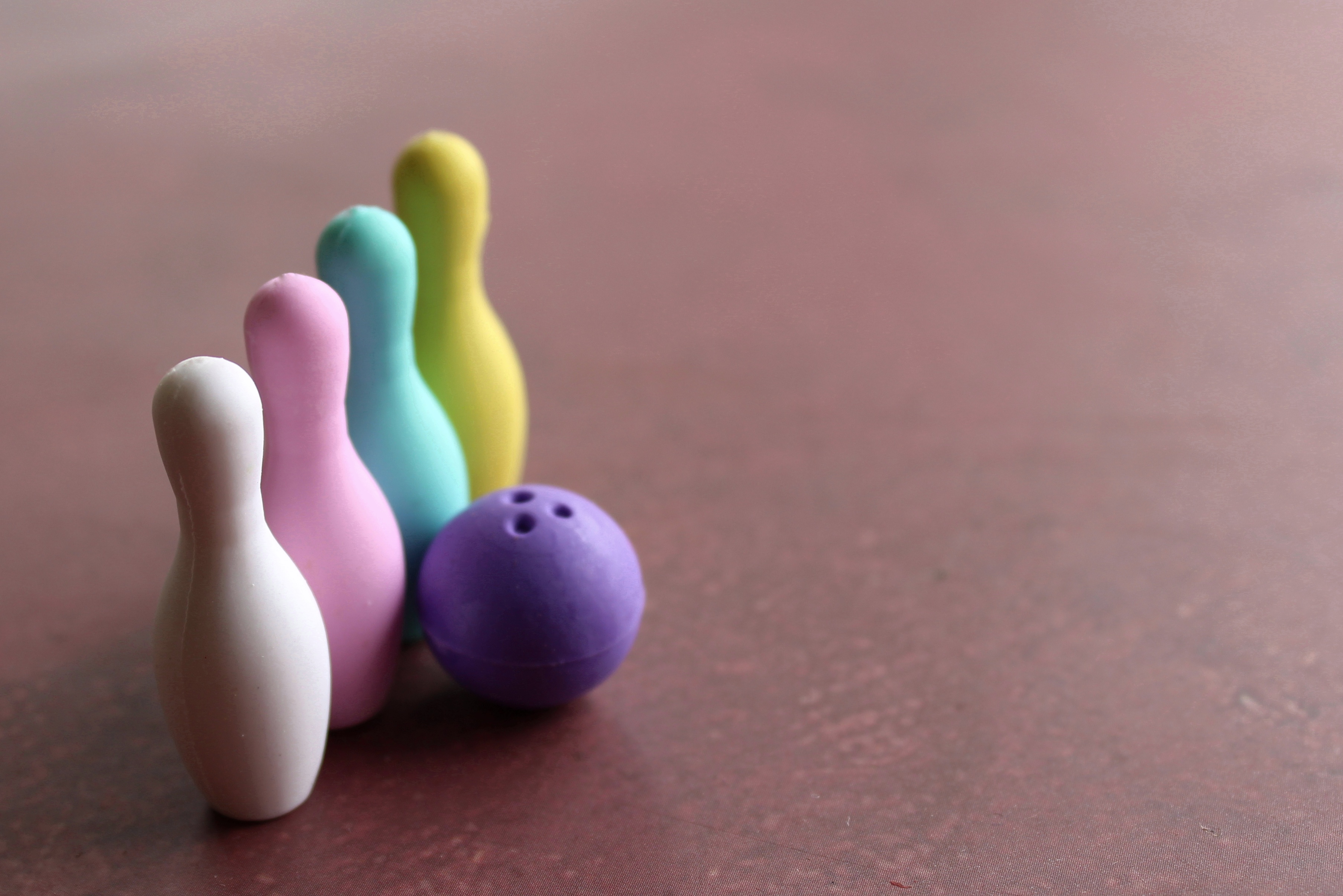 Bowling ball and colorful bowling pins with copy space.